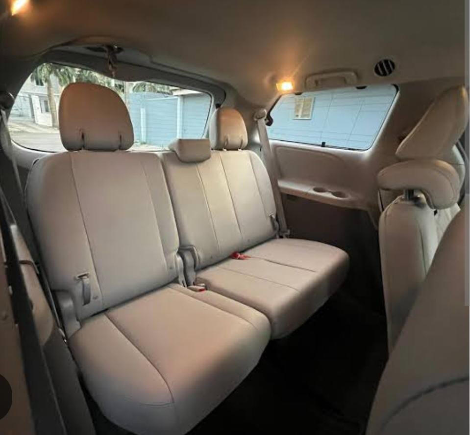 Rear passenger seating Beige rear passenger seats inside a minivan.