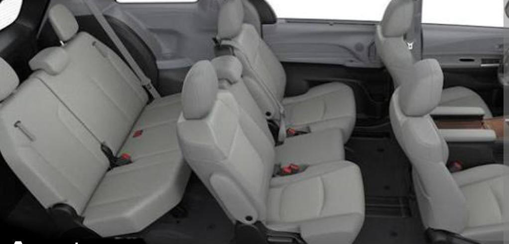 Three-row passenger seating Multiple rows of passenger seats inside a minivan.